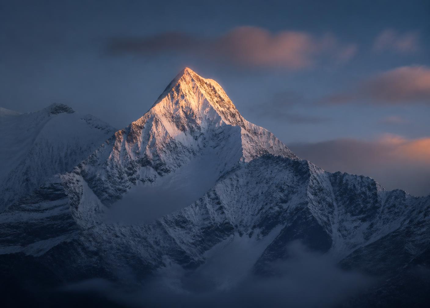 Snow-covered mountain peak at dawn